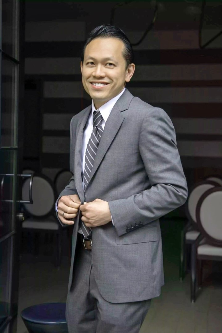 Portrait of Dr. Nguyen in business attire.